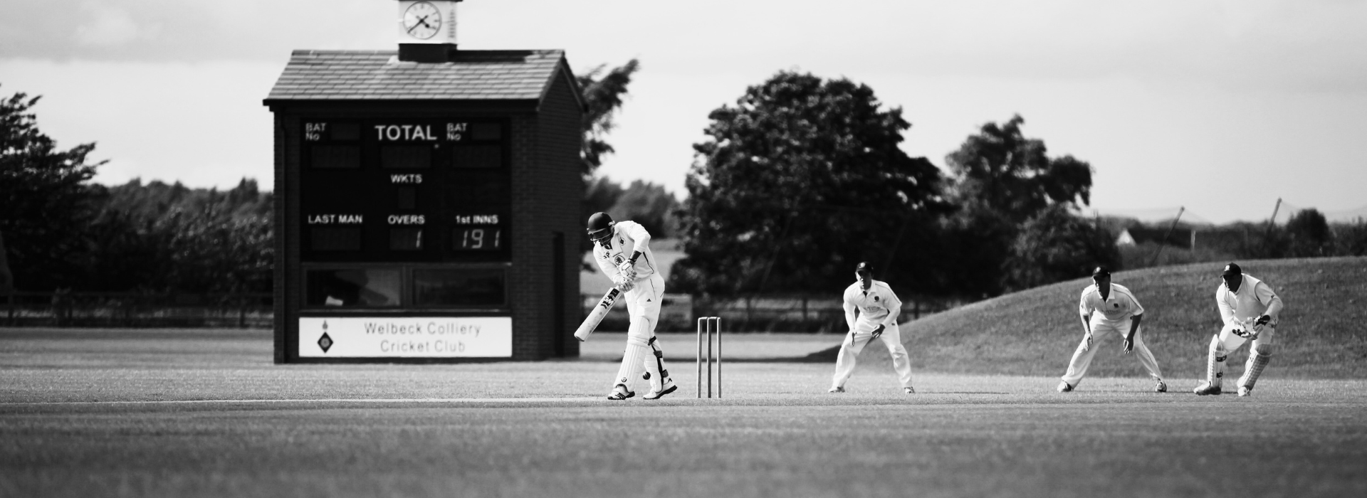 Cricket players in black and white.