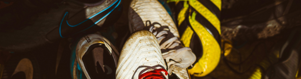 Pile of used dirty football boots