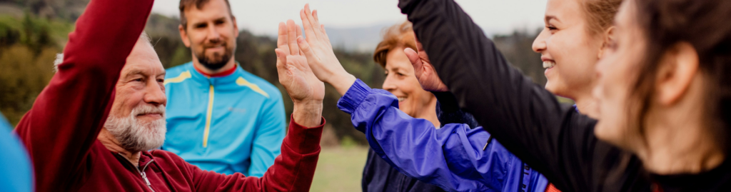 A group of smiling adults high five each other